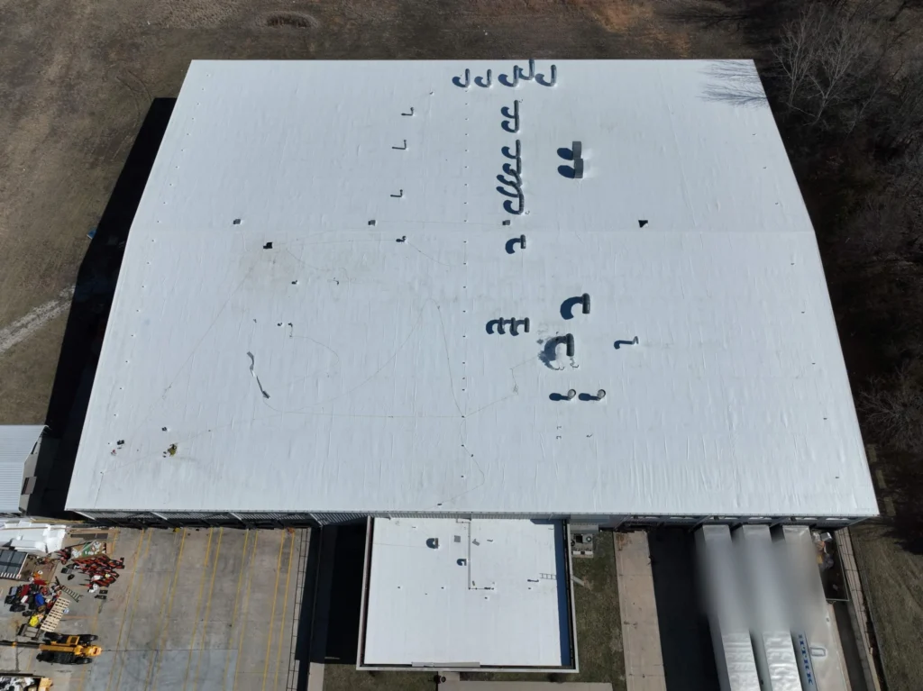 Completed white membrane roof over a 53,000 square foot facility, top down aerial view